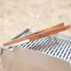Close-up of grill tongs on a metal grill. Produktbild-Vorschau