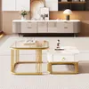 A set of two modern coffee tables with gold metal frames and marble-look tops, placed on a striped rug in a well-lit living room setting. Náhľad obrázku produktu