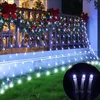 Christmas lights draped over a balcony railing and extending onto the lawn. Produktbild-Vorschau