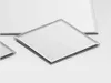 Several square mirrored tiles are arranged on a white surface. Produktbild-Vorschau