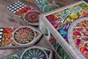 A close-up shot of the Sagrada board game box and several player boards, arranged on a wooden surface. Podgląd zdjęcia produktu