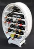 A white wooden wine rack shaped like a barrel, filled with wine bottles, against a black background. Produktbild-Vorschau