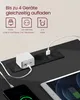 A close-up view of a black power strip with two AC outlets and two USB ports, with a white power adapter plugged into one of the USB ports. A smartphone and a tablet are also shown, connected to the power strip and charging. Produktbild-Vorschau