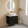 A modern bathroom vanity with a black cabinet, white sink, and round illuminated mirror. Produktbild-Vorschau