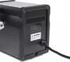 A close-up view of the back of a black electronic device, showing a label with product information and a power cord. Produktbild-Vorschau