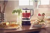 A kitchen scene with a food processor and ingredients for making salsa or tacos. Voir les images du produit