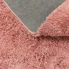 A close-up view of the underside and fluffy top of a pink rug. Produktbild-Vorschau