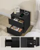 A black nightstand with two drawers, a phone charging on top. Náhled obrázku produktu