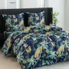 A bed with a duvet cover and pillows featuring a jungle print with leopards and tropical plants. Náhled obrázku produktu