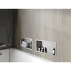 A modern bathroom with a bathtub and built-in shelves in the wall. Náhled obrázku produktu