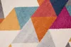 A close-up view of a geometric patterned rug with triangles in various colors. Náhled obrázku produktu