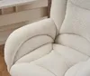 Close-up view of a plush, cream-colored armchair with a textured, teddy-like fabric. Produktbild-Vorschau