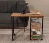 A side table with books and a drink next to a sofa. Voir les images du produit