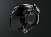 A black motorcycle helmet on a black background. Voir les images du produit