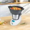 A multi-cooker filled with colorful vegetables sits on a wooden countertop, with kitchen cabinets and a sink in the background. Produktbild-Vorschau