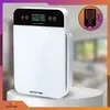 A white air purifier is displayed on a white pedestal, with a blurred background of a room. Podgląd zdjęcia produktu