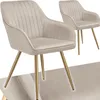 Two beige upholstered dining chairs with gold legs are shown against a white background. Produktbild-Vorschau