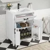 A white bathroom vanity with a sink and open doors, revealing storage shelves with towels and bottles. Podgląd zdjęcia produktu