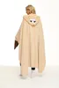A woman wearing a sloth-themed hooded blanket. Produktbild-Vorschau