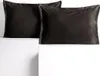 Two dark brown pillowcases are displayed on a white surface. Produktbild-Vorschau