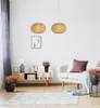 A living room scene with a sofa, a cabinet, plants, and pendant lights. Podgląd zdjęcia produktu