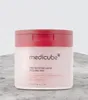 A product shot of a skincare jar on a textured surface. Voir les images du produit