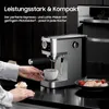 A person is using an espresso machine to make coffee, with a cupcake and a plate of food nearby. Náhľad obrázku produktu
