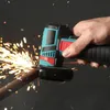 A hand is holding a mini angle grinder that is cutting a metal rod, creating sparks. Náhled obrázku produktu