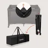 An image showing a travel crib being folded and placed into a carrying bag. Voir les images du produit