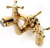 A shiny gold-colored faucet with two cross-shaped handles and a spout. Produktbild-Vorschau