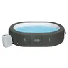 An inflatable hot tub filled with blue water, with a pump unit attached to the side. Produktbild-Vorschau