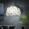 A modern living room with a concrete wall, a sofa, and a pendant light. Produktbild-Vorschau