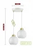 A white double pendant light with glass globe shades and gold accents, shown against a white background with measurement indicators. Produktbild-Vorschau