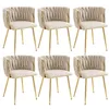 Six ivory upholstered dining chairs with gold metal frames are arranged in two rows of three against a white background. Anteprima dell’immagine prodotto