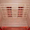 Interior view of a wooden sauna with glowing red infrared heating elements. Produktbild-Vorschau