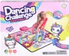 A young girl is posing on a dancing mat with unicorn graphics, which is part of the product packaging for a "Dancing Challenge Partymat". Produktbild-Vorschau