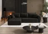 A modern living room with a dark gray sectional sofa, fireplace, and coffee tables.