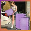 A woman is loading luggage into the trunk of a car. Náhled obrázku produktu
