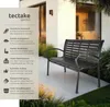 A black metal garden bench is shown outdoors on a patio, with text describing its features. Náhled obrázku produktu