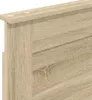 Close-up view of a wooden headboard with a light brown oak finish. Voir les images du produit
