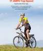 A man riding a bicycle on a grassy hill with a blue sky in the background. Produktbild-Vorschau