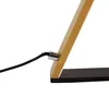 A close-up shot of the base of a modern LED table lamp, showing the connection point of the power cord to the lamp's frame. Náhľad obrázku produktu