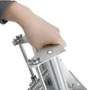 A hand is gripping a metal handle of a vertical potato chip slicer. Náhled obrázku produktu