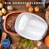 A Römertopf (Roman pot) casserole dish filled with a stew, placed on a wooden table with ingredients like potatoes and herbs around it. The lid of the casserole dish is also shown. Produktbild-Vorschau