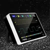 A digital oscilloscope is displayed on a textured dark surface. Náhled obrázku produktu