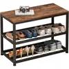 A shoe rack with a bench top, displaying various shoes on three shelves. A camera and a book are on the bench top. Produktbild-Vorschau