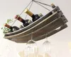 A wooden wine rack hanging from the ceiling, holding wine bottles and wine glasses. Produktbild-Vorschau