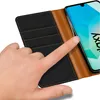 A hand is touching a smartphone in a flip case. Anteprima dell’immagine prodotto