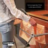 A person is hanging a towel on a drying rack in a kitchen. Produktbild-Vorschau