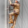 A person climbing a ladder attached to a building. Produktbild-Vorschau